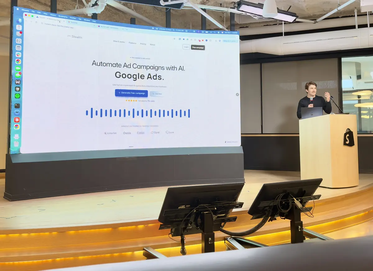 Tomas Kolafa presenting Bytown from the podium at Shopify, a Google Ads campaign on the screen behind him